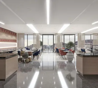 a dining room with tables and chairs and windows at Crowne Plaza Resort Petra by IHG in Wadi Musa