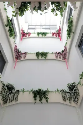 an overhead view of a white building with plants at Nishan Hotel in Amman