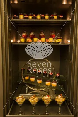 a refrigerator filled with lots of cupcakes at Seven Roses Hotel in Amman
