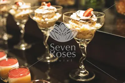 a group of wine glasses filled with desserts on a table at Seven Roses Hotel in Amman