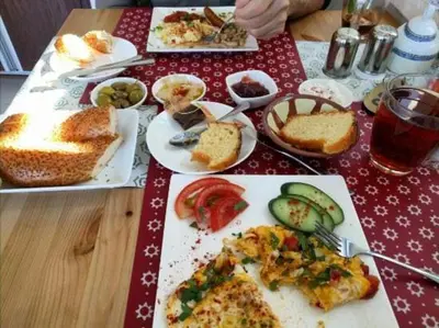 a table with plates of food on top of it at Zaman Ya Zaman Boutique Hotel in Amman