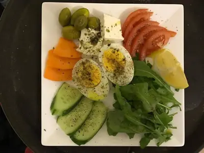 a plate of food with fruit and vegetables on it at Zaman Ya Zaman Boutique Hotel in Amman
