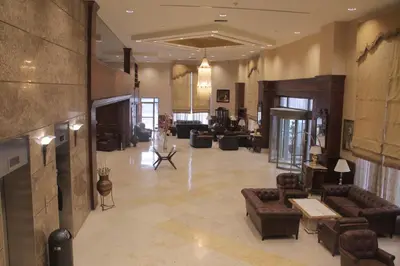 a large living room with couches and a fireplace at Le Vendome Hotel in Amman
