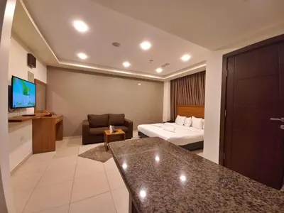 a hotel room with a bed and a couch at Lujain Hotel فندق النور واللجين in Amman