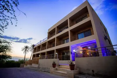 a building with purple lights on the side of it at Thara Real Estate in Sowayma