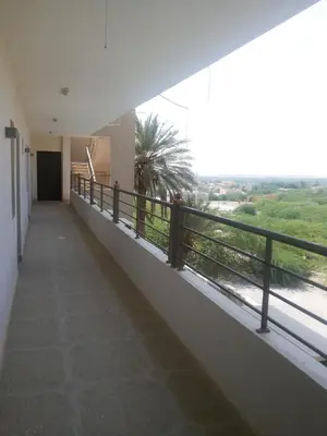 a balcony of a building with a view of a river at Thara Real Estate in Sowayma
