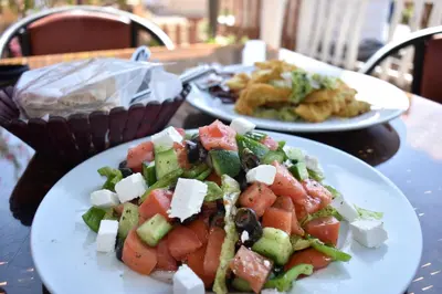 two plates of food sitting on a table at Bedouin Garden Village, hotel Dive in Aqaba