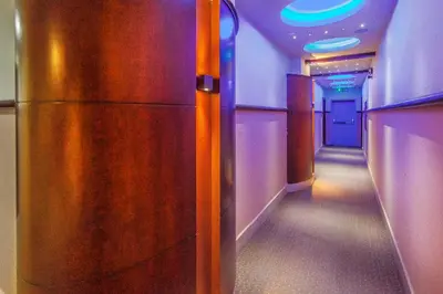 a corridor in an airplane with purple lights at Sofia Hotel in Amman