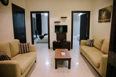 a living room with two couches and a coffee table at Madina Suites in Amman