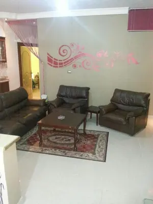 a living room with couches and a coffee table at Z apartment in Az Zarqa