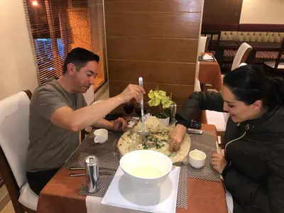 a man and a woman sitting at a table at P Quattro Relax Hotel in Wadi Musa