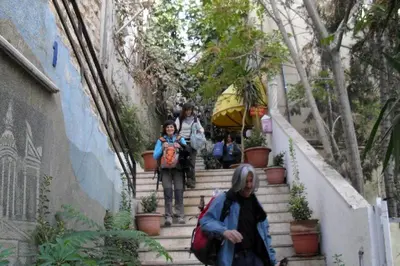 a group of people walking down some stairs at Farah Hotel in Amman