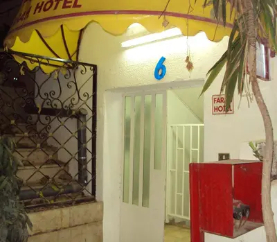 a door to a hotel with a sign on it at Farah Hotel in Amman