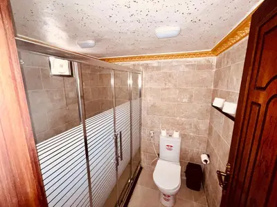 a bathroom with a toilet and a glass shower at Rum Stars Camp in Wadi Rum