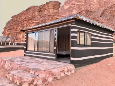 a black and white house in the desert at Milky Way Bedouin Camp in Wadi Rum