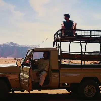 a man sitting in the back of a pickup truck at Bedouin Traditions Camp in Wadi Rum