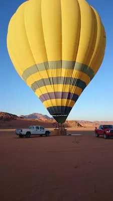 a yellow hot air balloon in the desert at Bedouin Traditions Camp in Wadi Rum
