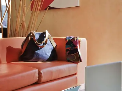two bags sitting on top of a couch at ibis Amman in Amman