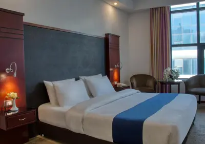 a hotel room with a large bed and a window at Torino Hotel Amman in Amman