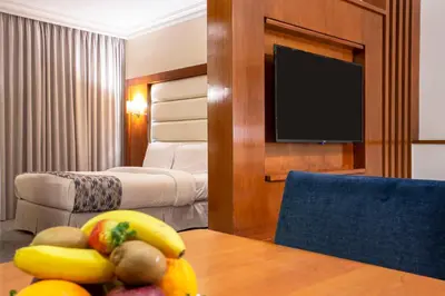a hotel room with a table with fruit on it at Sadeen Amman Hotel in Amman