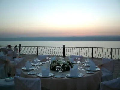 a table set up for a wedding with a view of the water at Dead Sea Spa Hotel in Sowayma