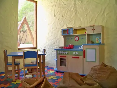 a toy kitchen with a toy stove and a table at Ma'in Hot Springs in Sowayma