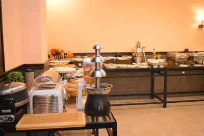 a buffet line with food on a table at Tilal Almadina Hotel & Suites in Amman