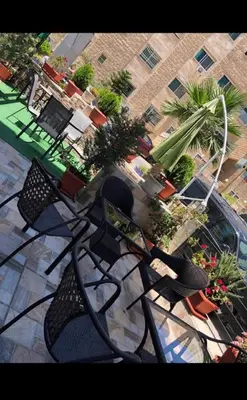 an overhead view of a patio with chairs and plants at Tilal Almadina Hotel & Suites in Amman