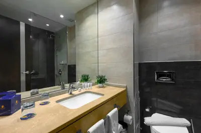 a bathroom with a sink and a mirror at Sulaf Luxury Hotel in Amman
