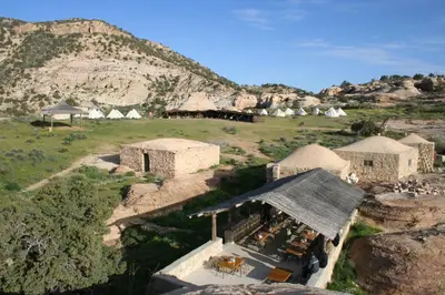 an aerial view of a village with tents in a mountain at Rummana Campsite in Dana