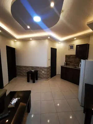 a living room with a ceiling with a blue light at Al Fakher Hotel Apartments & Suites in Amman