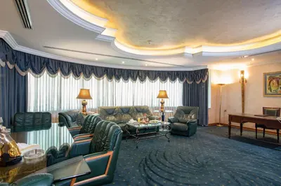 a living room with a couch and a table at Bristol Hotel in Amman
