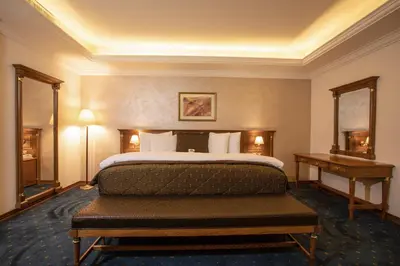 a hotel room with a bed and a desk at Bristol Hotel in Amman