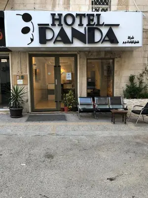 a hotel yard with benches in front of a building at Panda Hotel Apartments in Amman