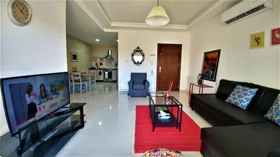 a living room with a couch and a flat screen tv at Double Key by HR in Amman