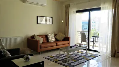 a living room with a couch and a table at Double Key by HR in Amman