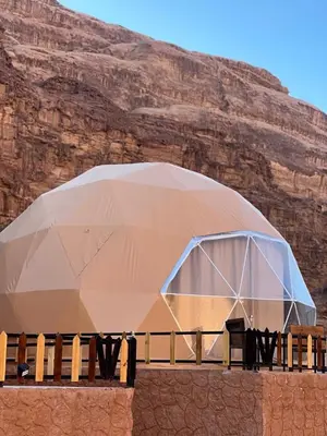 a large tent in front of a mountain at Bedouin life Camp in Wadi Rum