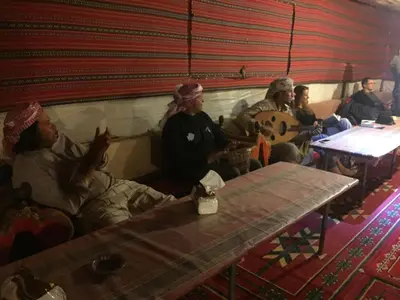a group of people sitting on a couch in a room at Jordan Tracks Bedouin Camp in Wadi Rum