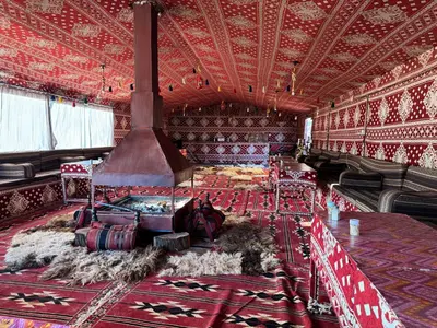 a large room with a stove in the middle at Desert Bird Camp in Wadi Rum