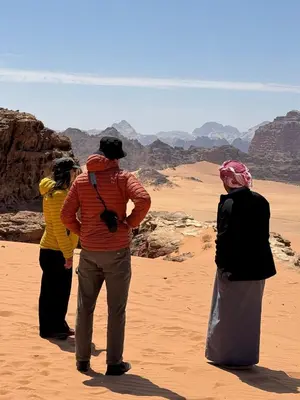 a group of people standing in the desert at Wadi Rum Desert Secret in Wadi Rum