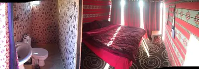 a small bedroom with a bed and a toilet at Wadi Rum Starlight Camp in Wadi Rum