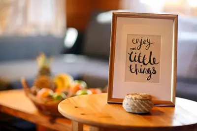 a picture frame on a table with a bowl of fruit at Mountain Breeze Lodge & Resort in Al Salt