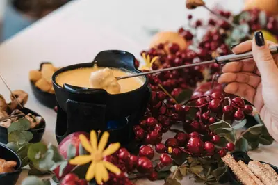 a table topped with a plate of food with a drink at Mountain Breeze Lodge & Resort in Al Salt