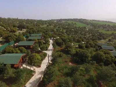 an aerial view of a village with trees and buildings at Mountain Breeze Lodge & Resort in Al Salt