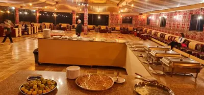 a restaurant with a buffet line with food on it at Hasan Zawaideh luxury camp 2 in Wadi Rum