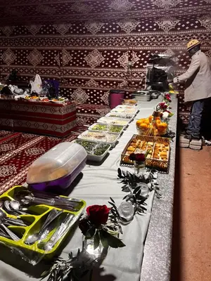 a buffet line with plates of food on a table at Wadi Rum Sky Tours & Camp in Wadi Rum