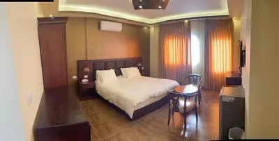 a hotel room with a bed and a table at Esperanza Petra in Wadi Musa