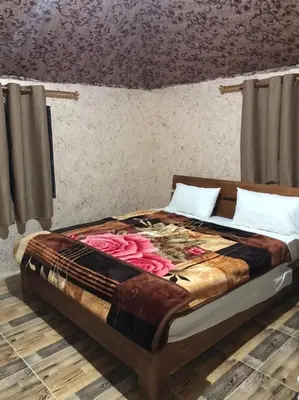 a bed sitting in a room with at Wadi Rum Quiet Village Camp in Wadi Rum