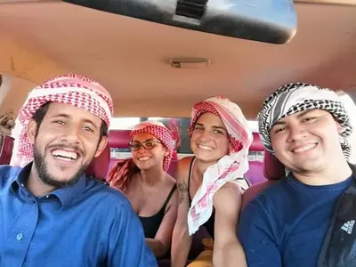 three people wearing turbans sitting in a bus at Welcome to Wadi Rum Camp in Wadi Rum