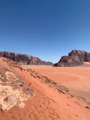 a view of a desert with rocks and a blue sky at Stargazing Camp & Tours in Wadi Rum